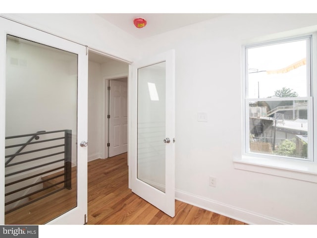 corridor with light hardwood / wood-style floors