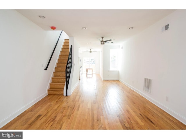 unfurnished living room with ceiling fan and light hardwood / wood-style flooring