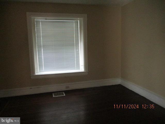 unfurnished room featuring dark hardwood / wood-style floors