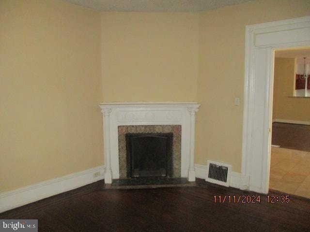 unfurnished living room with tile patterned flooring and a fireplace