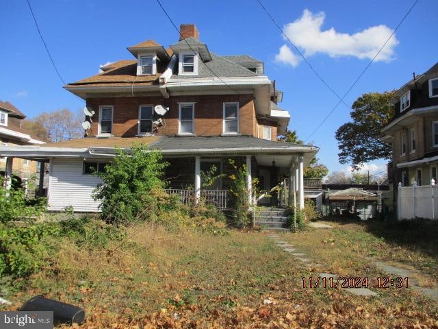 back of property featuring a porch