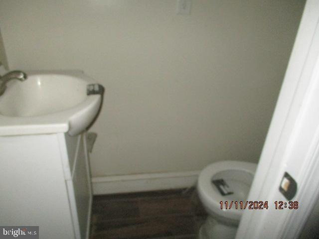 bathroom featuring hardwood / wood-style floors, vanity, and toilet