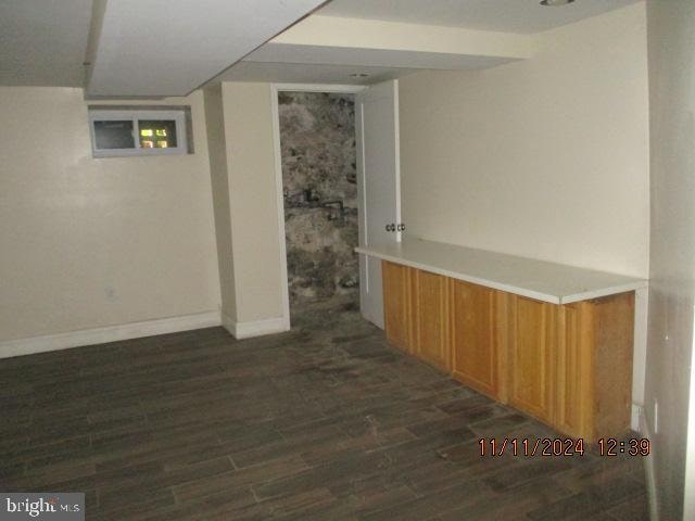 basement featuring dark hardwood / wood-style floors