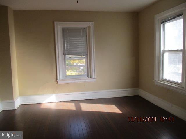 spare room with dark hardwood / wood-style flooring