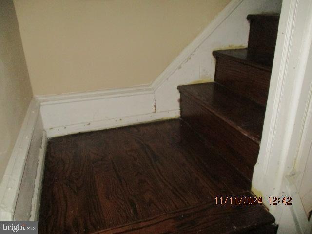 stairs featuring wood-type flooring