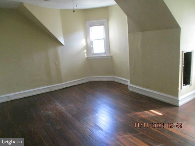 bonus room with ceiling fan, dark hardwood / wood-style flooring, and lofted ceiling