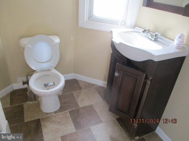 bathroom featuring vanity and toilet