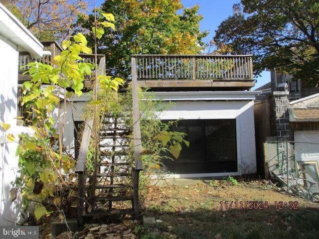 back of property featuring a balcony