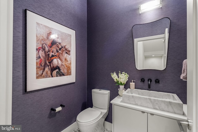 half bathroom with vanity and toilet