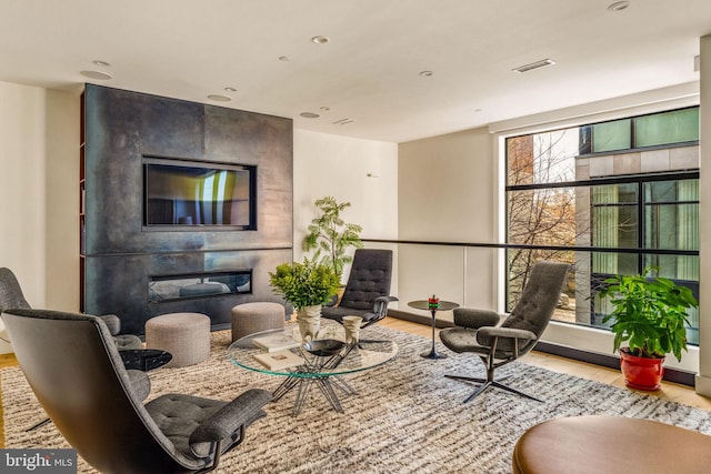 interior space with visible vents, a fireplace, and light wood finished floors