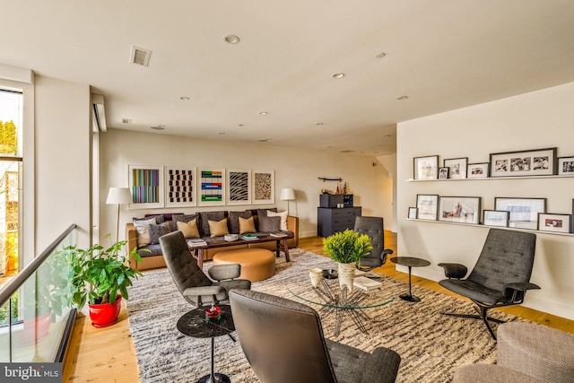 living room featuring light wood-type flooring, visible vents, and recessed lighting