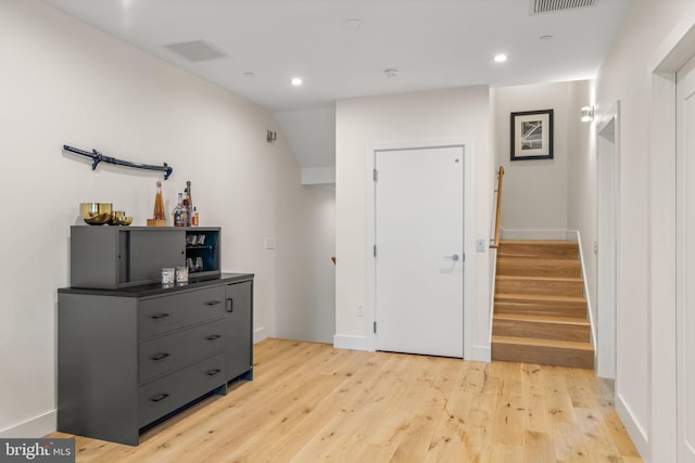 interior space featuring light wood-style floors, baseboards, and recessed lighting