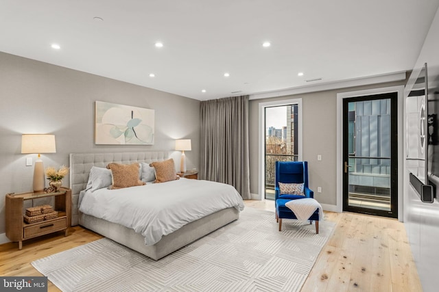 bedroom with light wood-type flooring, access to exterior, and recessed lighting