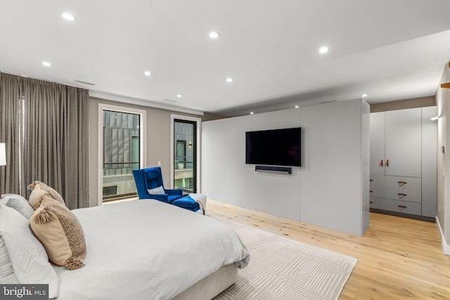 bedroom featuring recessed lighting, visible vents, and light wood finished floors