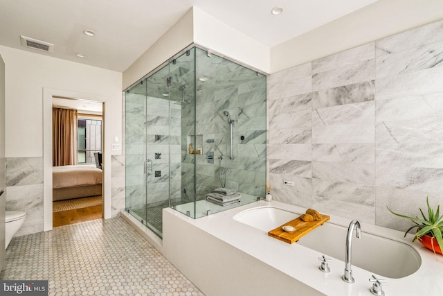 bathroom with connected bathroom, visible vents, tile walls, a bath, and a stall shower