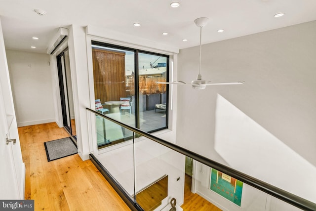 hallway featuring light wood-style floors and recessed lighting