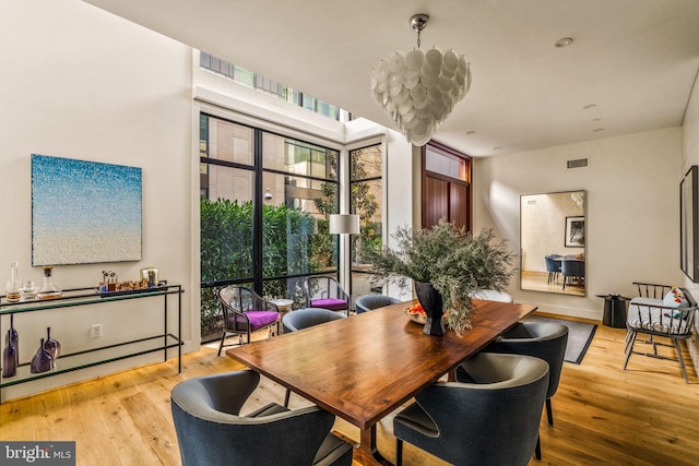 dining space with visible vents and light wood finished floors