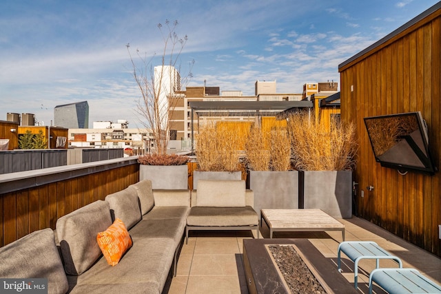 view of patio / terrace with an outdoor living space with a fire pit