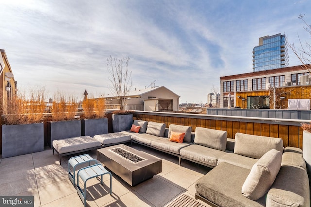 view of patio / terrace with an outdoor living space with a fire pit