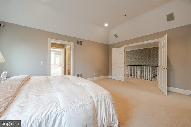 bedroom with lofted ceiling and light carpet