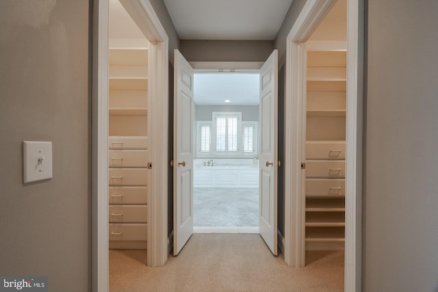 hallway featuring light carpet