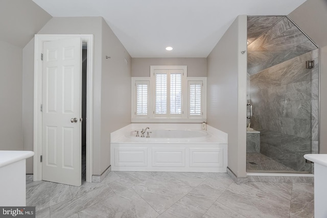 bathroom featuring separate shower and tub