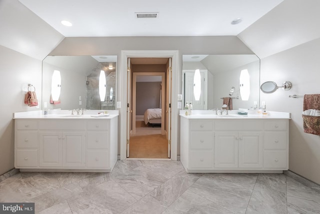 bathroom featuring vanity and lofted ceiling