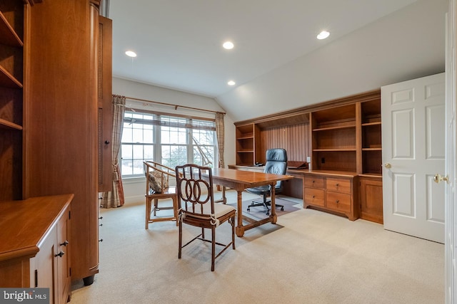 home office with light colored carpet and vaulted ceiling