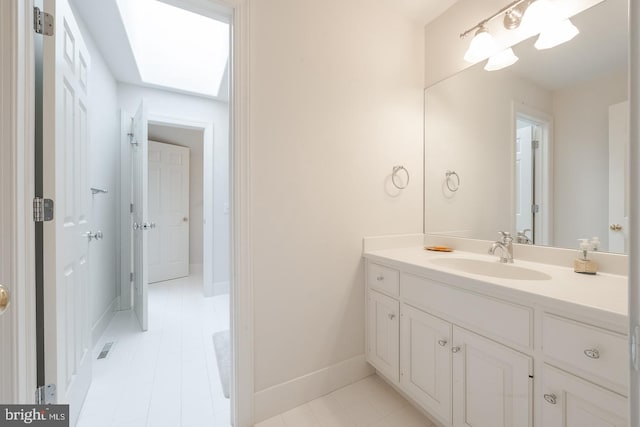 bathroom featuring vanity and a skylight