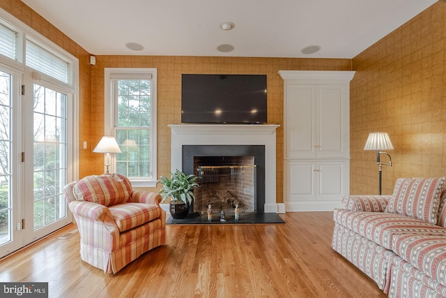 living room with a healthy amount of sunlight and light hardwood / wood-style floors