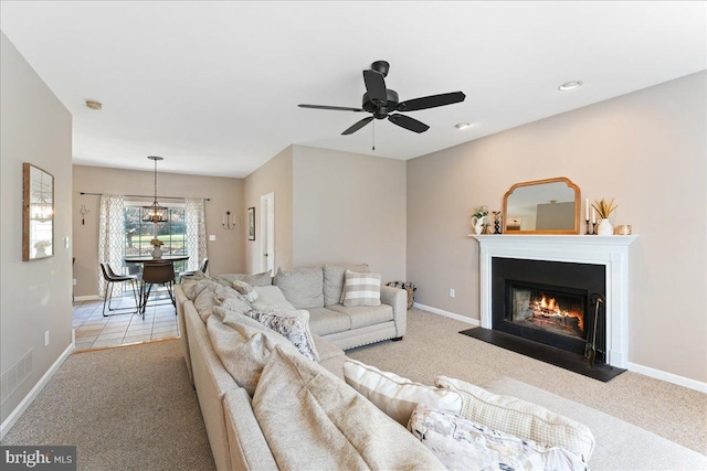 carpeted living room featuring ceiling fan