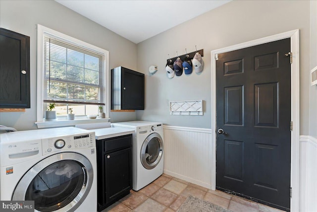 laundry area with cabinets and separate washer and dryer