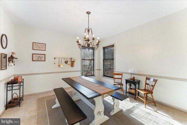 carpeted dining area with an inviting chandelier