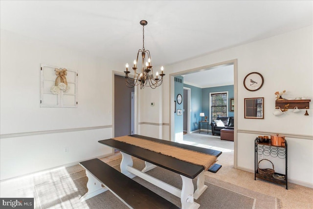 carpeted dining area featuring a notable chandelier