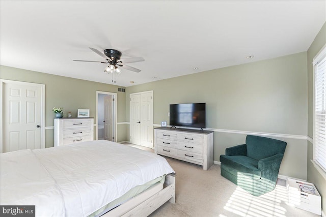 bedroom with light carpet and ceiling fan