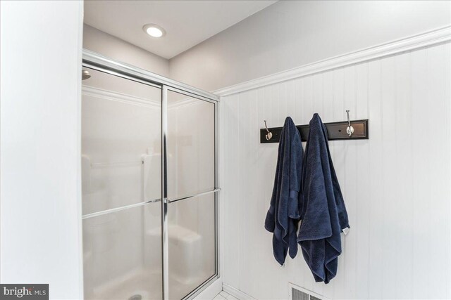 bathroom with a shower with shower door