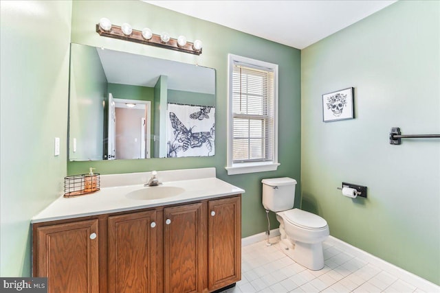 bathroom with tile patterned floors, vanity, and toilet