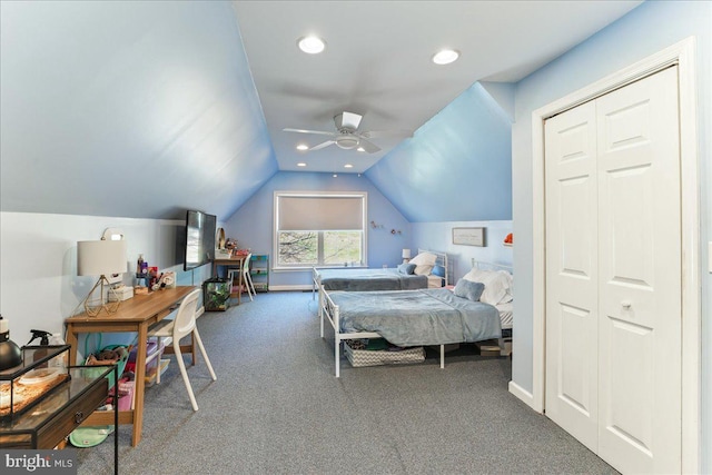 carpeted bedroom featuring ceiling fan, a closet, and lofted ceiling