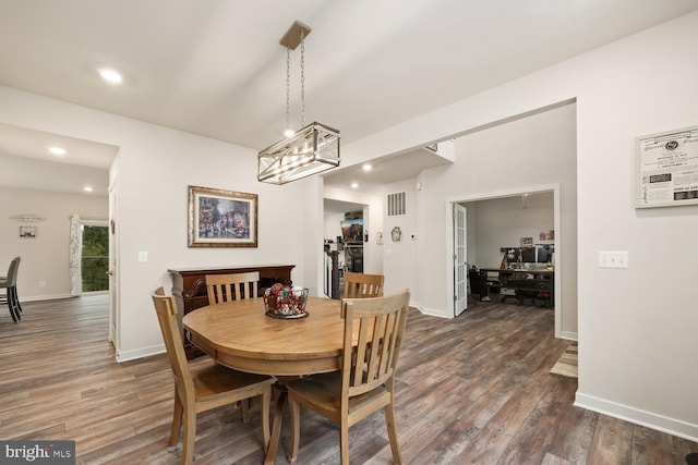 dining room featuring visible vents, dark wood finished floors, and baseboards