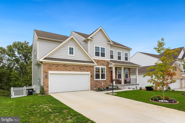 view of front of house with driveway, a garage, fence, and a front yard