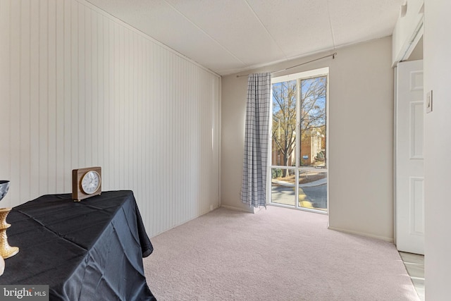 interior space with a textured ceiling and light colored carpet