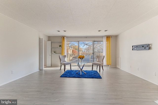 dining area featuring a textured ceiling and hardwood / wood-style flooring