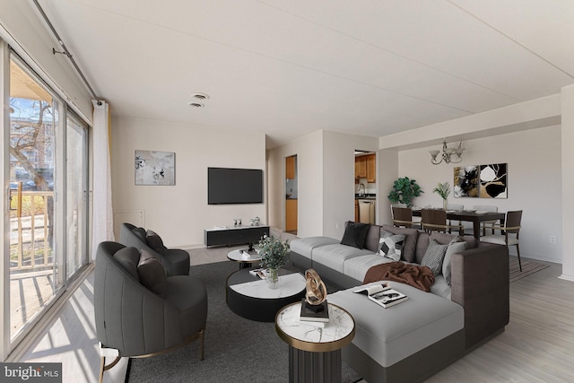 2630 Fort Farnsworth Rd Unit 149, Alexandria, VA 22303 - living room with a chandelier and light wood finished floors