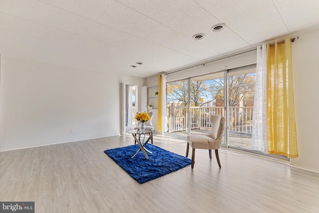 sitting room with wood-type flooring