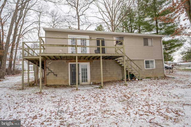 snow covered house featuring a deck