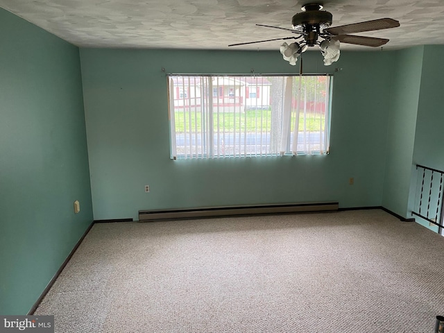 spare room with carpet flooring, a textured ceiling, baseboard heating, and ceiling fan