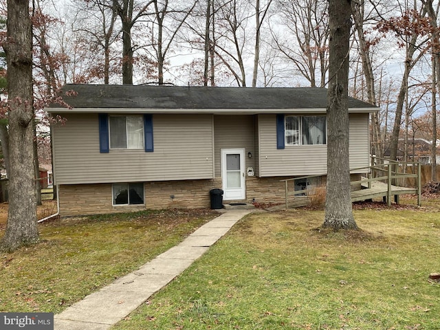 split foyer home with a front lawn