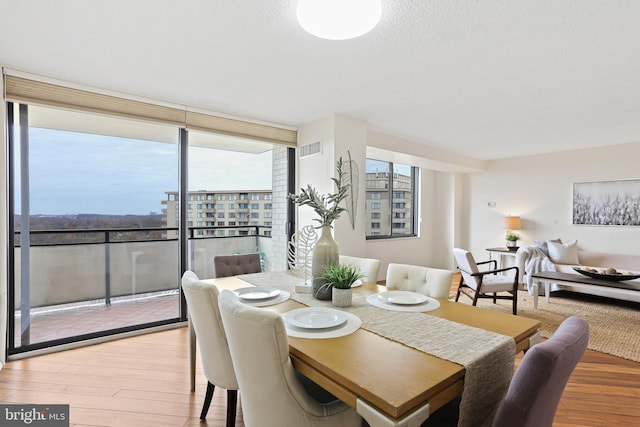 dining room with hardwood / wood-style floors and floor to ceiling windows