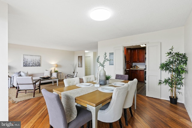 dining space with dark hardwood / wood-style flooring