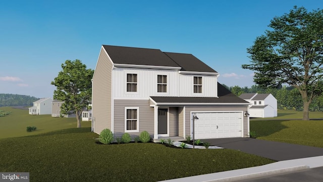 view of front of home with a front yard and a garage